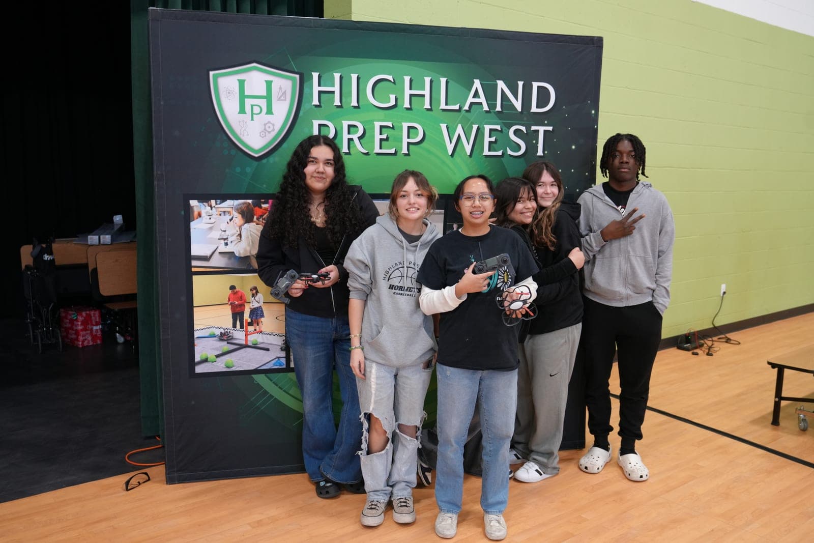 Highland Prep West students at a school event in front of the school banner