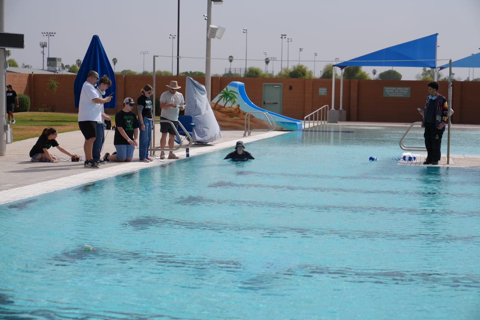 Students testing a SeaPerch underwater robot in the water